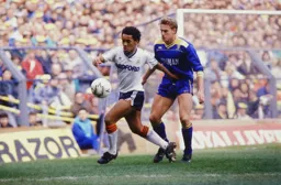 Mark Stein shields the ball from John Scales