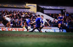 Kingsley Black challenges for the ball with Vinnie Jones