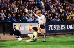 Tim Breacker is tackled by Tony Spearing