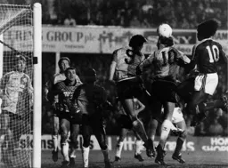 Ricky Hill leaps and attempts a header at the back post