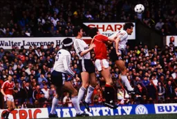 With Dave Beaumont in support, Danny Wilson heads the ball away from Steve Bruce