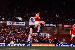 Mick Harford clashes in mid air with Paul McGrath