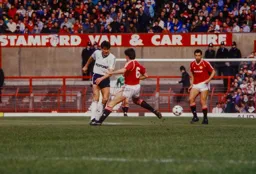 Mick Harford sends the ball past former Hatter Mal Donaghy