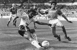 Ricky Hill attempts to cut the ball back