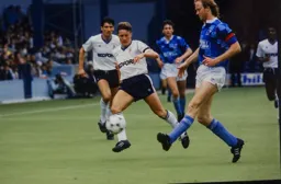 Mark Wright knocks the ball away from Danny Wilson