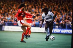 Ricky Hill knocks the ball past Peter Shirtliff