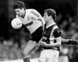 Mick Harford wins a header against Alvin Martin