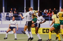 Mick Harford and Ricky Hill look for the ball