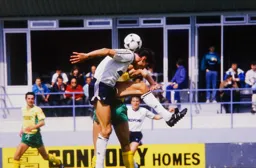 Mick Harford bends his back as he goes for the ball