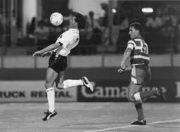 Roy Wegerle uses chest control to shield the ball from Nigel Pearson