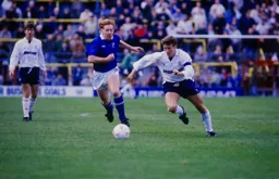 Danny Wilson takes the ball past Gary Waddock
