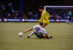 Tim Breacker with a strong tackle