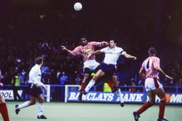 John Dreyer competing for the ball with Blades Brian Deane