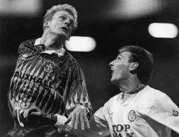 Iain Dowie rises high above Leeds midfielder Snodin