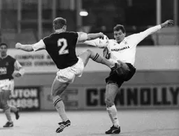 Lars Elstrup competes for the ball with Tim Breacker