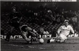 Dave Beasant saves as Iain Dowie slides in