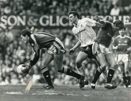 Sean Farrell eases Steve Bruce out of the way and making sure Les Sealey gathers the ball cleanly