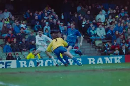 Kurt Nogan has the ball taken from his foot by Beasant