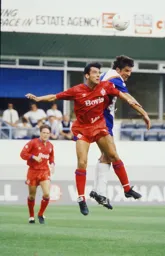 Mick Harford wins the header