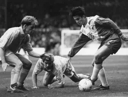 Ceri Hughes taking on two defenders