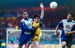 Brian Stein and Mick Harford are thwarted by a Chelsea leg