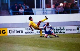 Julian James crashes to the ground following a clash with Paul Elliot