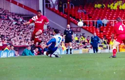 Paul Telfer takes the ball from John Barnes