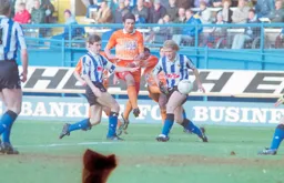 Mick Harford blasts through the defence