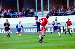 Mick Harford challenges Gary Pallister