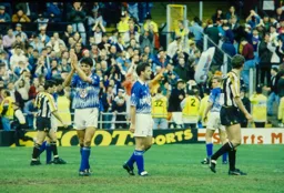Mick Harford applauds the fans