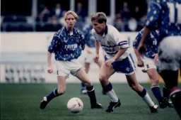 Julian James makes a break as the Blues player just looks rightly embarrassed at the kit they are wearing