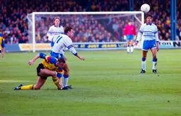 Scott Oakes just manages to get rid of the ball before the challenge