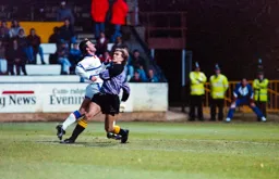 Phil Gray and Cambridge keeper both looking for the ball