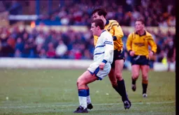 Steve Claridge being tightly marked
