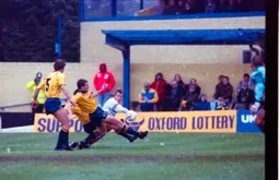 Steve Claridge gets the ball past two defenders