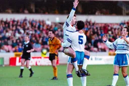 Ceri Hughes holds the goal scorer aloft