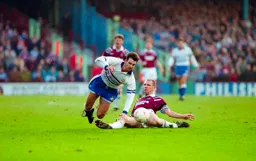 Phil Gray brought down by Hammers defender Alvin Martin