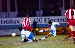 Scott Oakes gets a shot away even as he slips