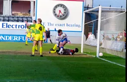 Phil Gray gets the ball in the net but it is ruled out for a foul on the keeper