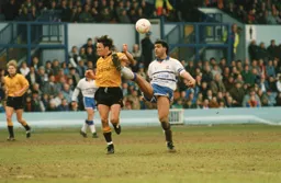 Chris Kamara wins the ball with a high boot