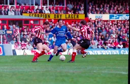 Phil Gray about to feel the full force of Terry Butcher