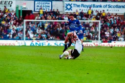 Paul Telfer hurdles his man