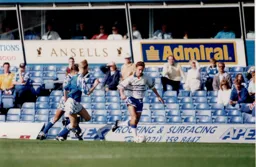 Scott Oakes gets away from two City defenders