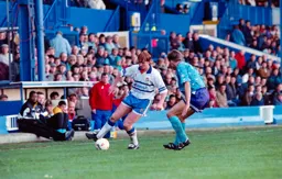 John Hartson takes on a defender under the watchful eye of David Pleat