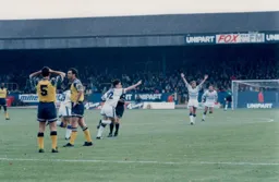 A hands on head moment for Les Robinson as Ceri Hughes celebrates his goal