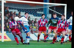 The ball flashes past Paul Telfer