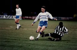 Alan Harper rides a tackle by Andy Cole