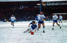Kerry Dixon competing for the ball in snowy conditions