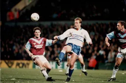 With Alvin Martin behind him Kerry Dixon looks to bring the ball under control