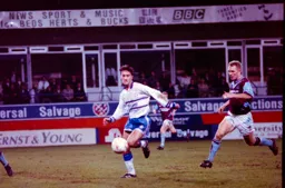 Scott Oakes beats Town former favourite Tim Breaker to the ball